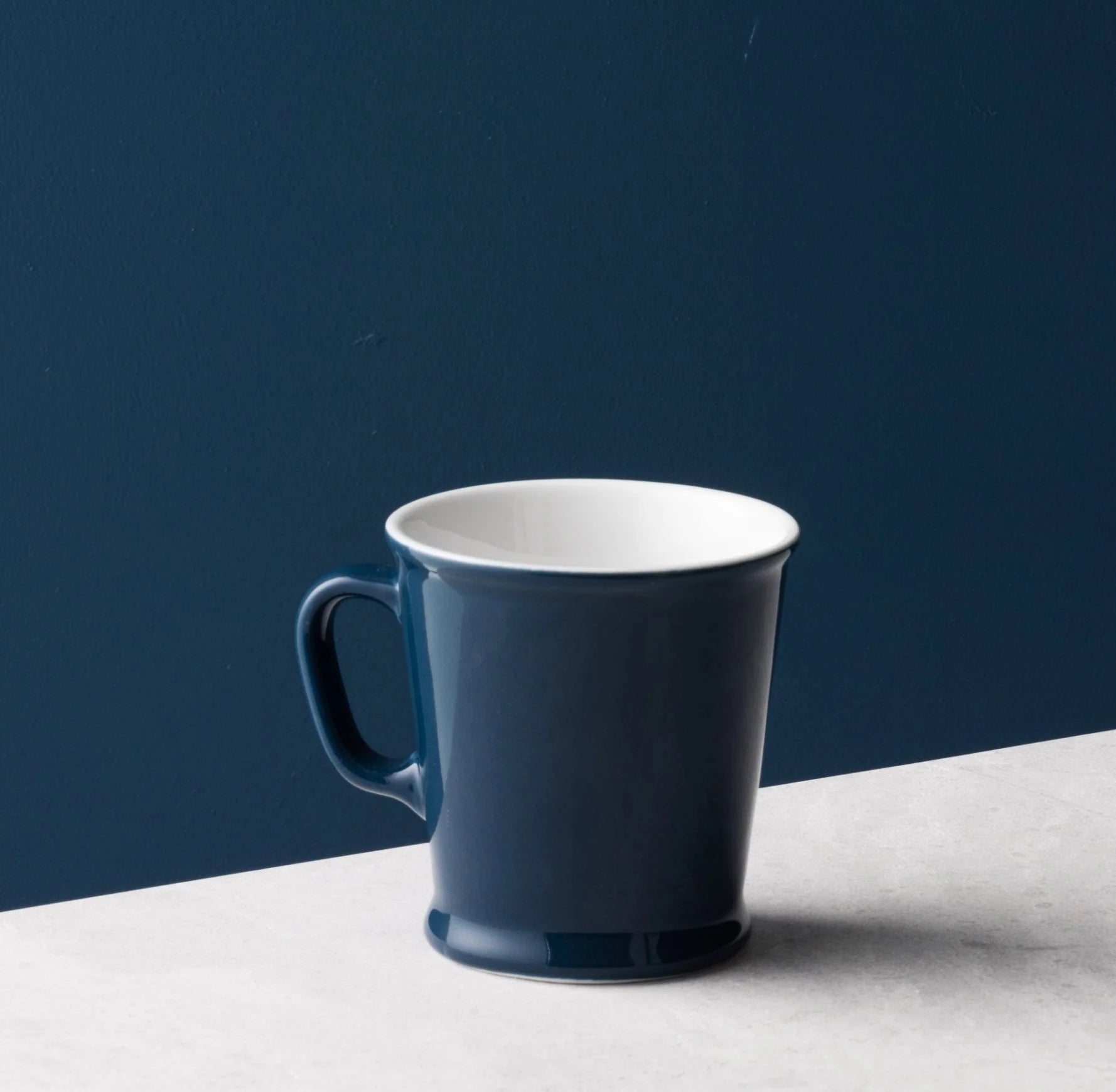 Two Acme Union Mugs Whale filled with hot Koko Samoa on a reflective surface, warm background — Aunty Tommy&