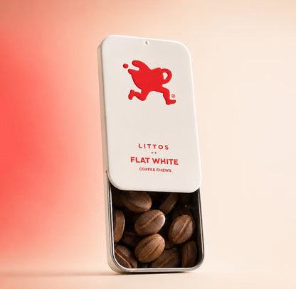 A metal tin of Littos Flat White coffee chews photographed against a plain background, showing the product name and branding on the tin.