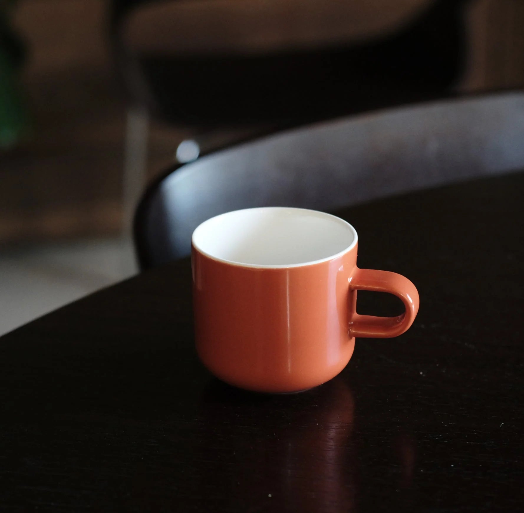 Acme Bobby Mug Clay 300ml terracotta orange mug on a dark surface with soft blurred background — Aunty Tommy&