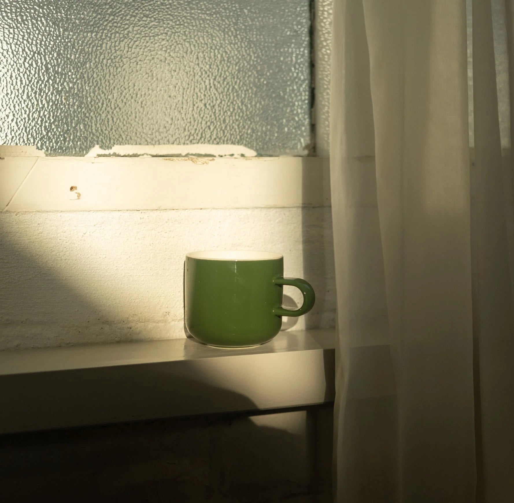 Acme Bobby Mug Kawakawa 300ml green porcelain mug on a windowsill in soft natural light — Aunty Tommy&